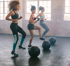 A group of women exercising with big balls