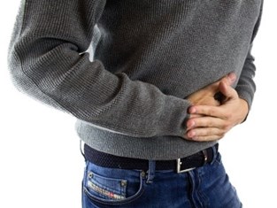 A man clutching his stomach due to the pain of a peptic ulcer. Picture pixabay.com