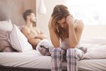 A couple in bed looking stressed. Source: Shutterstock 259619195